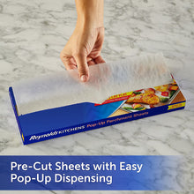 Reynolds Kitchens pop-up parchment sheet dispensed, held by hand