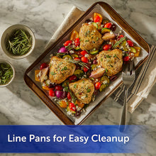 Reynolds Kitchens parchment lining a baking pan with roasted chicken