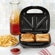 Black waffle and sandwich maker with plates open, showing two toast sections inside