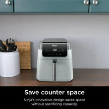 Ninja air fryer on a countertop, white body with black control panel and central basket