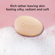 Caress daily silk soap bar, pale cream oval with embossed logo on soft foam
