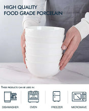 White ceramic food-grade dipping bowls stacked and held in hands