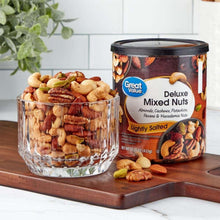Deluxe mixed nuts canister with lightly salted nuts beside glass bowl