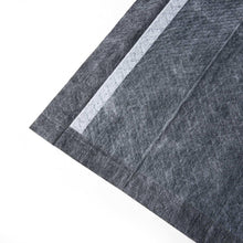 Dark charcoal training pad with a light white side stripe and folded edge.