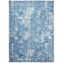 Blue area rug with distressed abstract pattern and short low-pile texture