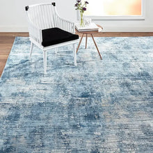 Blue area rug with distressed abstract bands and short low-pile texture