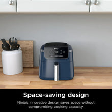 Navy Ninja air fryer on countertop with stainless handle, space-saving design