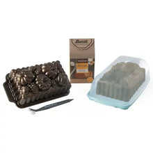 Nonstick bundt loaf pan with floral pattern, plus blue plastic loaf keeper
