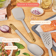 Silicone kitchen utensils set with light gray heads and gold-tone handles in cooking scene