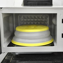 Yellow vented microwave splatter cover placed inside a microwave oven