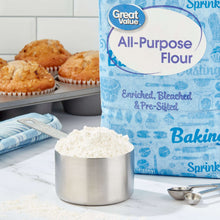 All-purpose flour bag with flour scoop and baking muffins on countertop