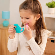Child holding a pink toy phone handset and makeup accessory during pretend play