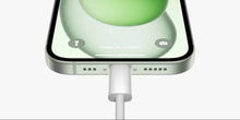 USB-C charge cable plug inserted in device port, white