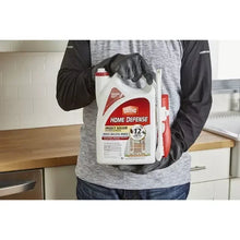 Ortho Home Defense insect killer jug with comfort wand in gloved hand