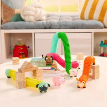 Farm animal sensory tubes arranged for play with five animal figures and blocks