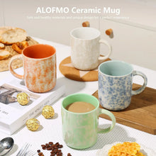 Ceramic mug set with orange, blue speckled, green, and white mugs with handles