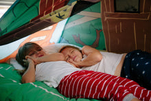 Tree house pop-up bed tent, kids lying down on green bedding with brown wall