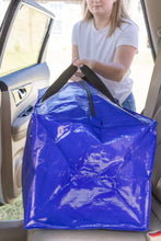 Blue heavy-duty moving packing bag being carried with backpack straps