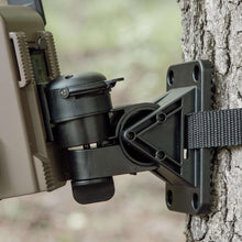 Trail camera flex mount bracket on tree showing mounting plate and cinch strap