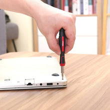 Hand using red precision screwdriver to tighten a screw on an electronics device