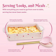 Pink lasagna pan with baked lasagna, turner tool, and heart-shaped spoon rest