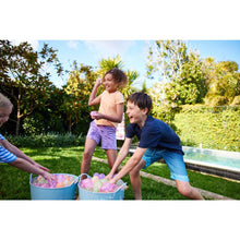 Children running with water balloons while playing with filled buckets