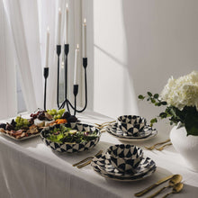 Black-and-white geometric ceramic dinnerware set with bowls and plates
