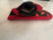Skillet handle cover with red border and chili pepper print, open top view