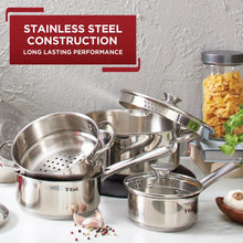 Stainless steel cookware set showing multiple pots and pans with black handles