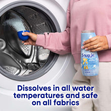 Snuggle Blue Sparkle scent booster bottle near a washing machine drum
