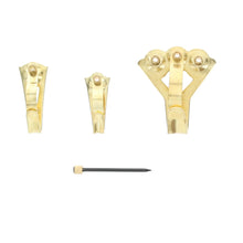 Brass picture hanger pieces and mounting nails, shown as a set