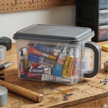 Clear plastic storage container with gray lid and side handle, filled with pantry items