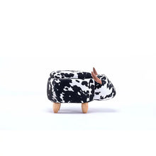 Cow print ottoman with open hinged lid and wooden legs