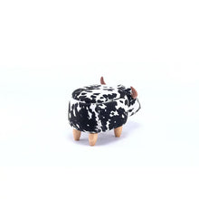 Cow-print ottoman with brown horn accents and four short wooden legs, rounded top