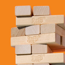 Close-up of light wood Jenga blocks stacked in an unstable tower