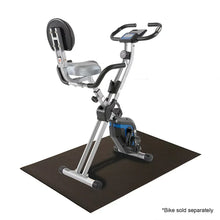 Fitness equipment mat, dark gray, on floor under exercise bike