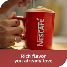 Nescafé instant coffee mug with frothy drink and red coffee canister