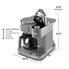 Grey KEURIG coffee maker shown at angle with open lid and black brew chamber