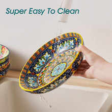 Colorful ceramic pasta bowl with ornate blue, green, and yellow medallion pattern, held by hand