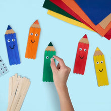 Hand placing a painted wooden craft stick among colorful character sticks.
