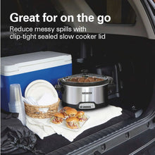Hamilton Beach slow cooker in a car cargo area with lid on and snacks nearby