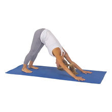 Blue yoga mat on floor for a stretching pose