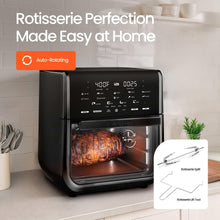 Black air fryer oven with rotisserie spit and accessories beside the unit