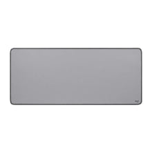 Mid grey desk mat with rounded corners and stitched edge, Logitech logo at bottom right
