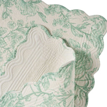 Quilted green-and-white table runner corner detail with floral print and wavy stitch quilting