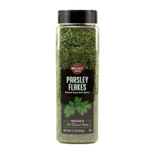 Jar of parsley flakes, clear sides show green dried herb flakes