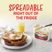Spreadable butter tub with canola oil next to toast and a glass of juice