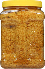 Jar of yellow rice with yellow lid, close-up view of yellow rice grains
