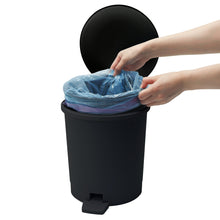 Black plastic bathroom step trash can with open lid and liner bag inside