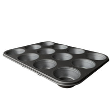 Gray nonstick muffin pan with 12 cup wells, slanted side view